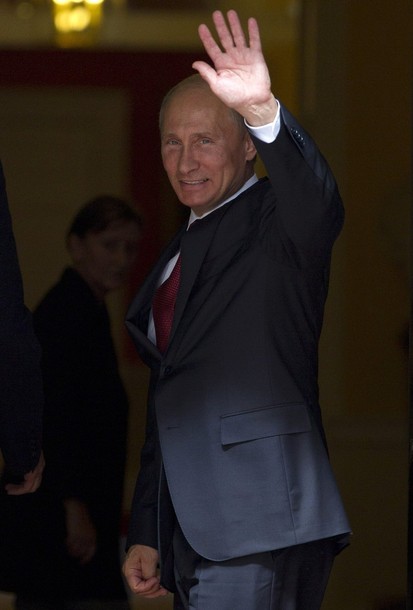 Russian President Vladimir Putin waves as he meets Prime Minister David Cameron at Downing Street in London